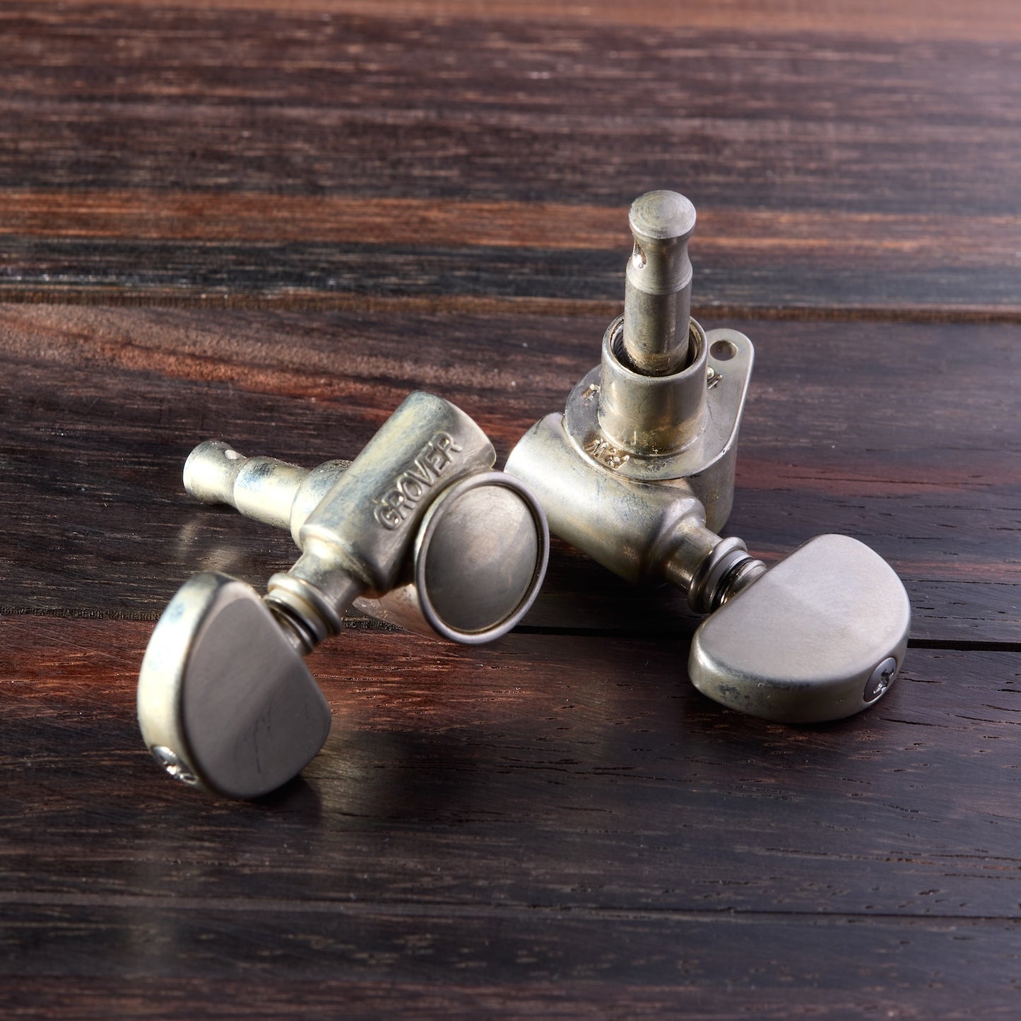 Tuning pegs of a guitar on a wooden surface