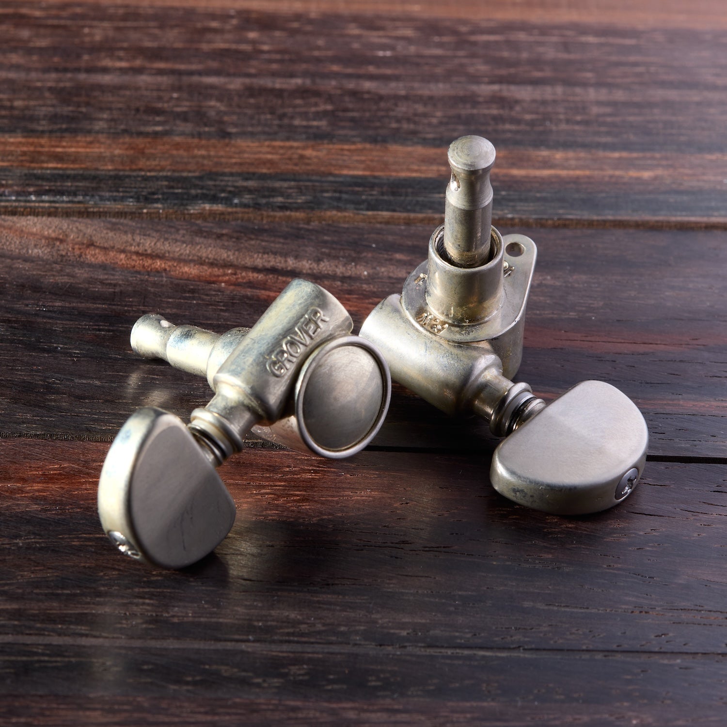 Tuning pegs of a guitar on a wooden surface