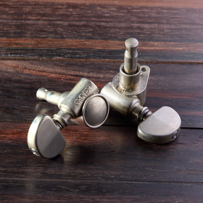 Tuning pegs of a guitar on a wooden surface
