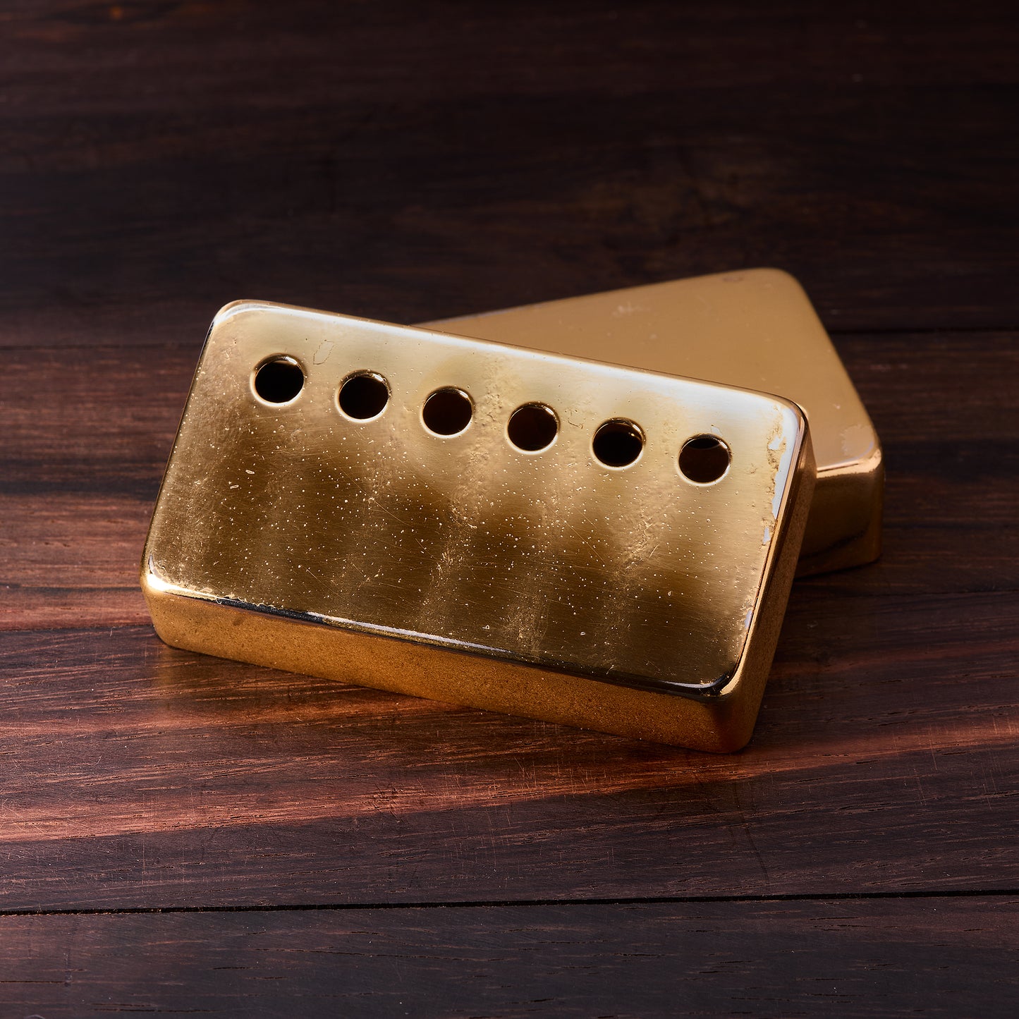 Gold pickup cover on a wooden surface